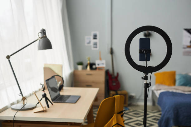 istock Round frame with smartphone in holder standing against workplace of designer 1487419582