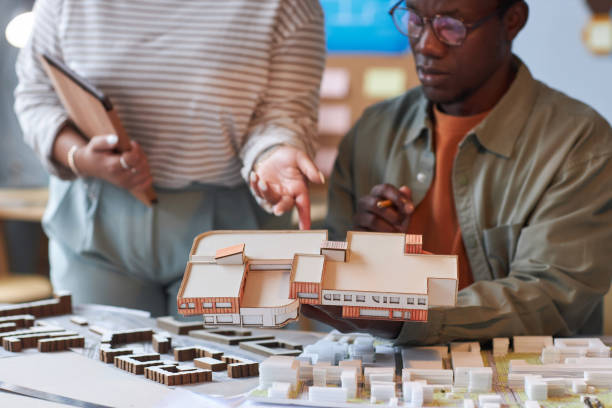 istock Colleagues discussing the mockup of building 1487423788