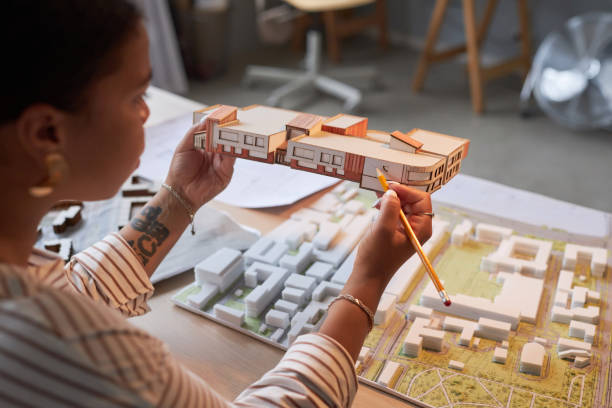 istock Architect working over new model of building 1487423795