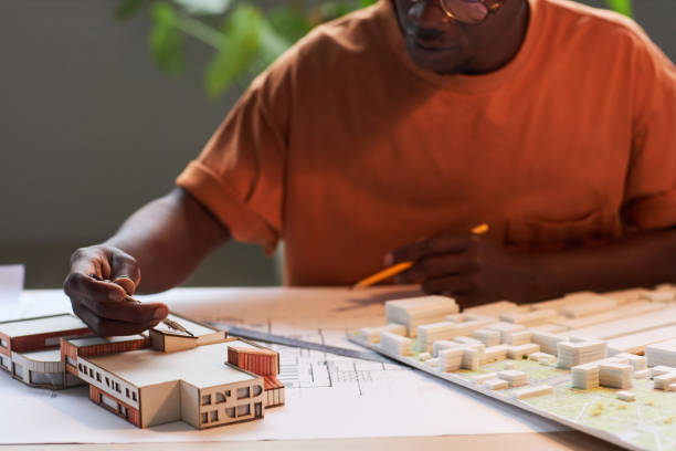 istock Architect drawing blueprint of new buildings 1487423845