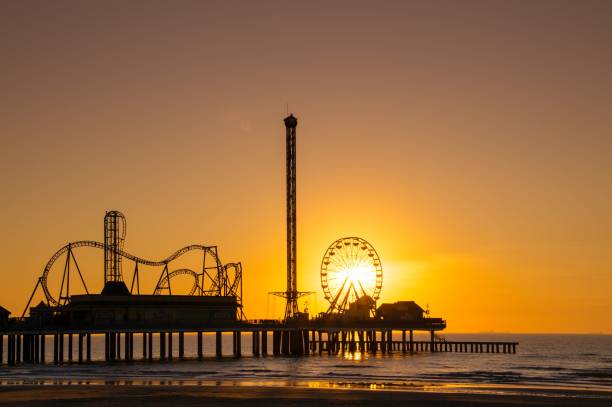 istock Amusement park on the beach at sunset 1487424079