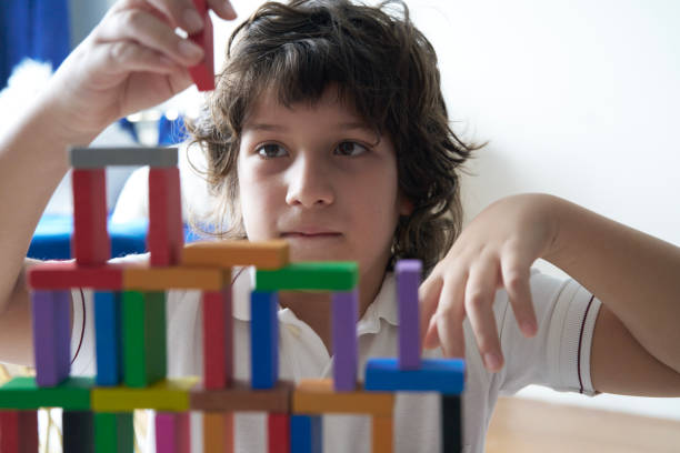 istock Cute Little Boy Playing with wooden block 1487426971