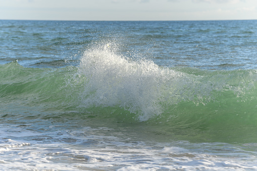 Small wave hitting the shore.
