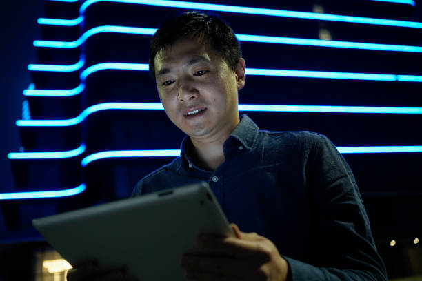 istock The businessman is carefully reading the information on the tablet computer 1487427282