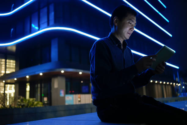 istock Asian businessmen use tablets under office blocks 1487427420