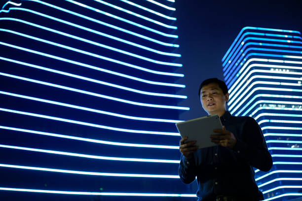 istock Asian businessmen use tablets under office blocks 1487427486