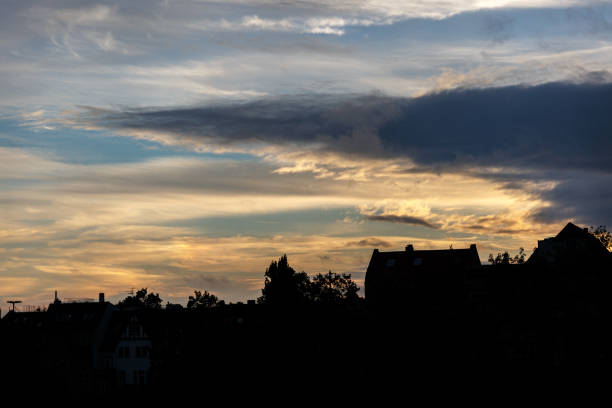 Dramatic sky with clouds on sunset over the city