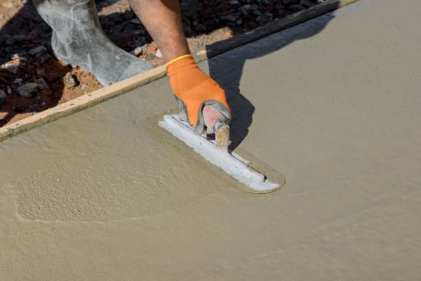 istock An employee plasters wet concrete cement floor using a trowel after concrete has just been poured 1487430078