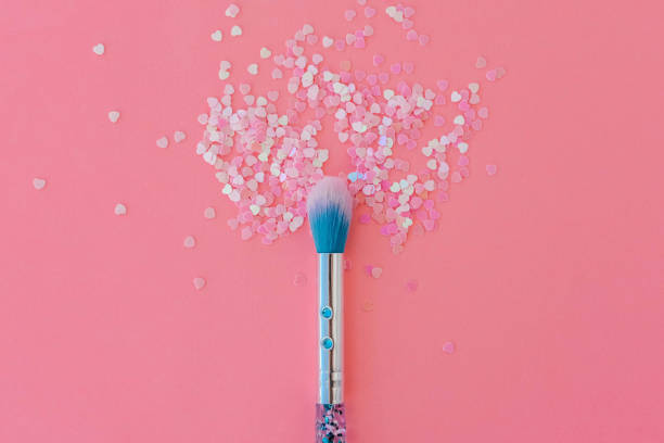istock Makeup brush and shiny pink sequins on a pink background. Festive magic makeup concept. Template for design, top view Flat Lay Copy space. 1487430905