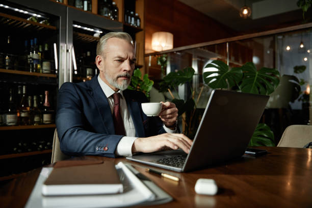 istock Businessman working online on laptop in cafe 1487434303