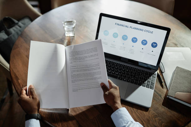 istock Businessman examining business contract in cafe 1487434320