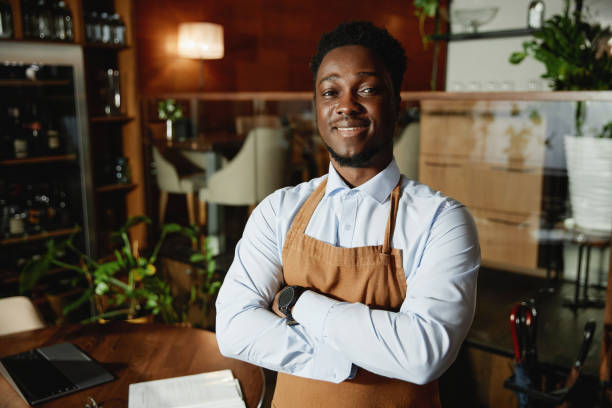 istock African American waiter working in restaurant 1487434353