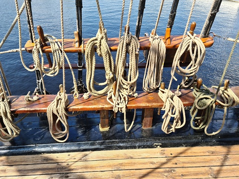 Many different ropes on an old wooden sailing ship are needed for the crew to travel the seas and oceans.