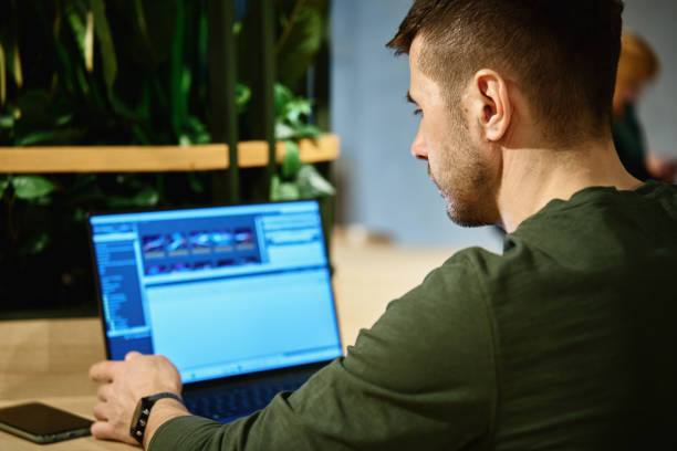 istock Male hand typing on laptop keyboard in cafe 1487436377