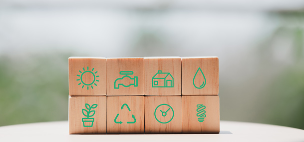 Set of wooden cubes with eco icons, concept of energy conservation and environment.