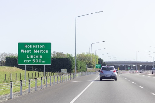 Rolleston, New Zealand - October 22, 2022: Traffic traveling along the Christchurch Southern Motorway towards Rolleston, West Melton, and Lincoln, under the Weedon Street flyover bridge.