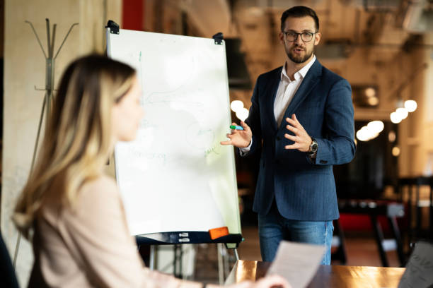 istock Businessman present his idea to working team. 1487438776