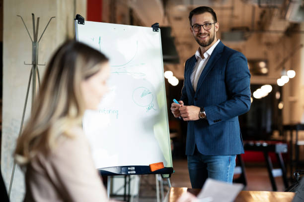 istock Businessman present his idea to working team. 1487438788