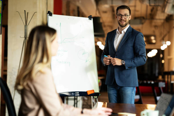 istock Businessman present his idea to working team. 1487438816