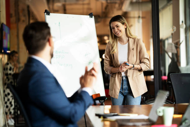 istock Businesswoman present her idea to working team. 1487438835