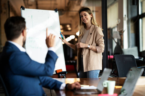 istock Businesswoman present her idea to working team. 1487438846