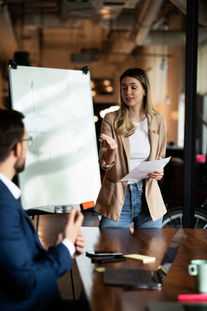 istock Businesswoman present her idea to working team. 1487438908
