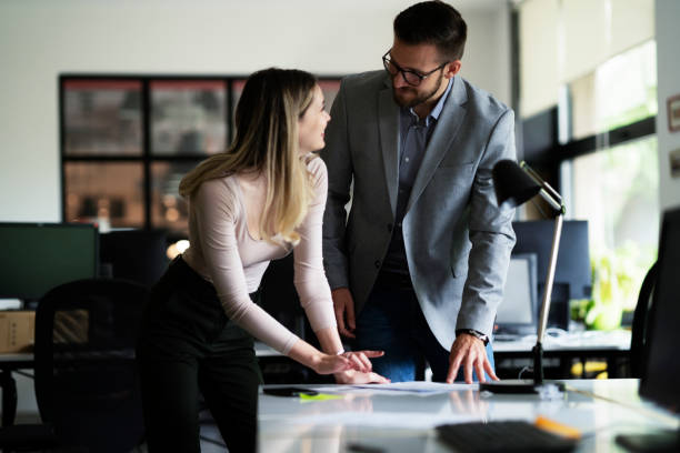 istock Colleagues working together in office. 1487438945