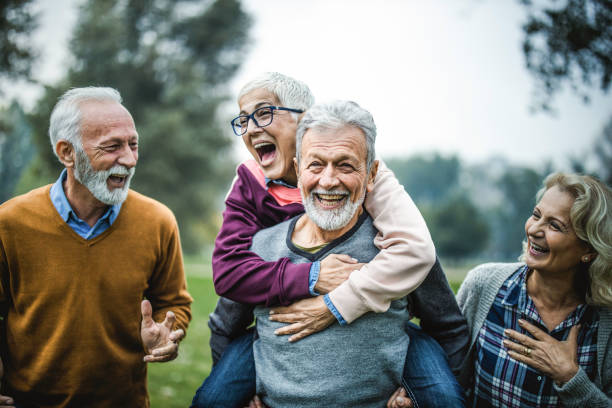 istock Happy senior couples having fun in autumn day at the park. 1487439012
