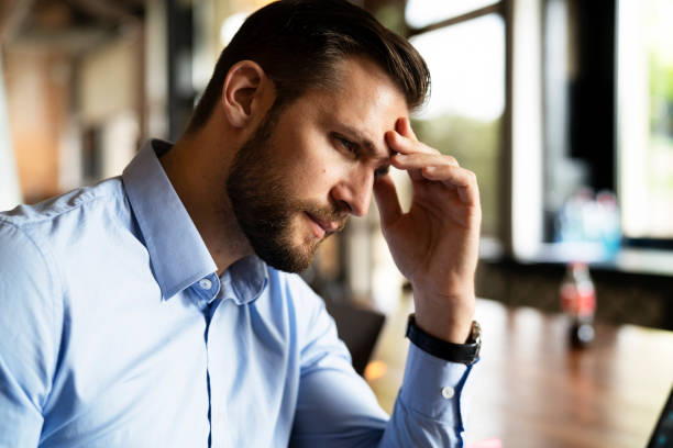 istock Man sitting in the office working on laptop 1487439183