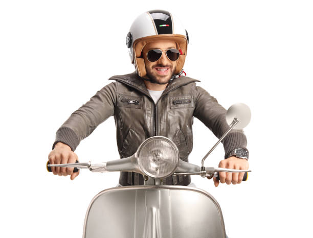 Man with a helmet in a leather jacket riding a scooter isolated on white background