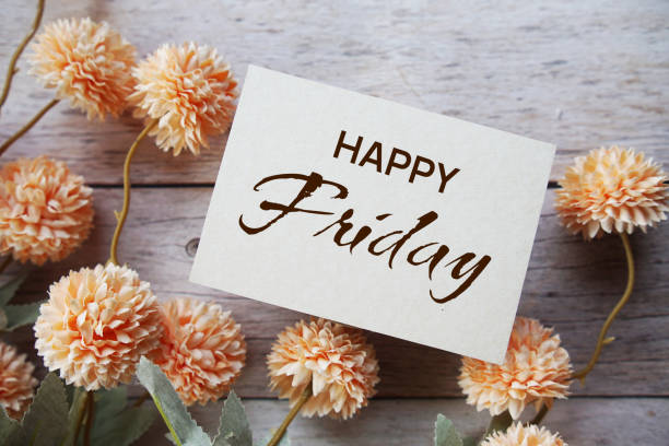 istock Happy Friday text message with flower decoration on wooden background 1487443589