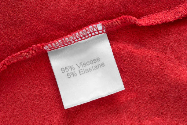 Fabric composition label Fabric composition clothing label on red fabric closeup viscose stock pictures, royalty-free photos & images