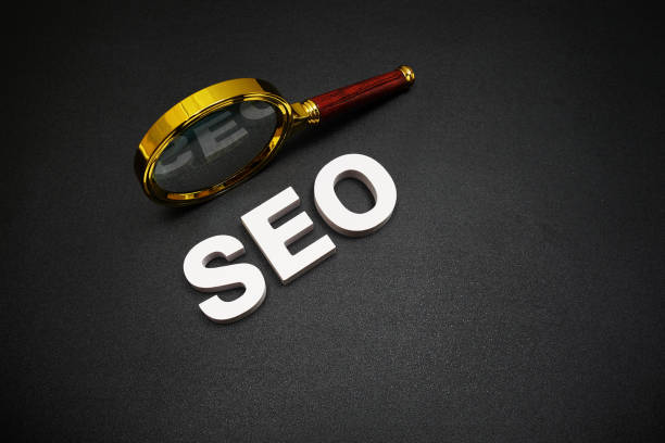 istock SEO (search engine optimization) text message with magnifying glass on black background 1487443733
