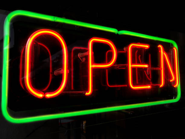istock open neon sign in shop window at night 1487444436