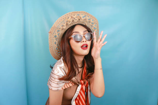 istock Young Asian confident woman is posing isolated by a blue background. 1487445769