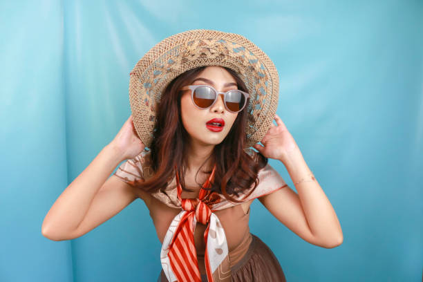 istock Young Asian confident woman is posing isolated by a blue background. 1487445782