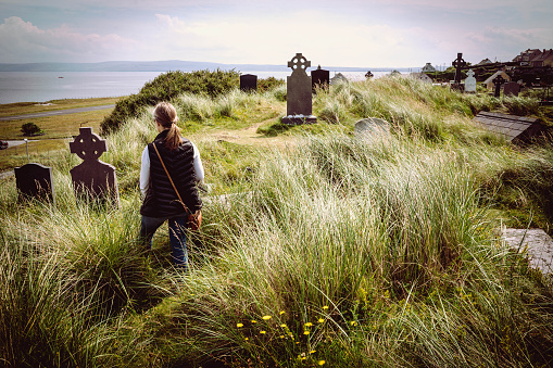 woman standing in irish cemetery