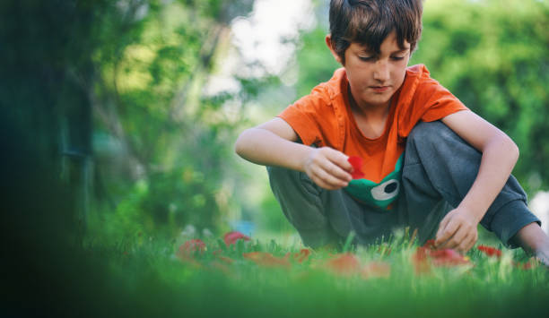 istock child playing with rose petals in the garden 1487449134