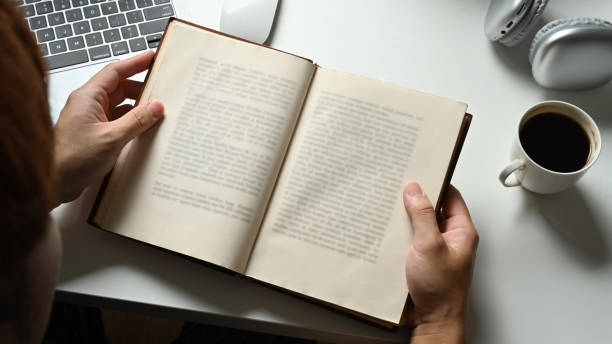 istock From above view of man reading interesting book. People, knowledge and education concept. 1487450546