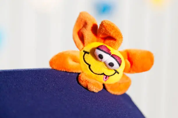 funny yellow and orange fabric flower with face for really small children
