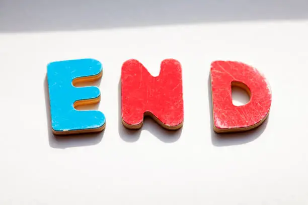 wooden letters in red and blue forming the word End