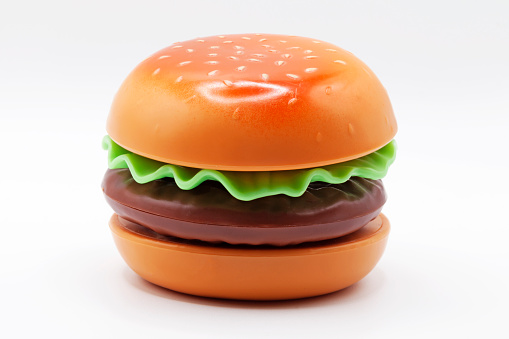 a plastic toy hamburger on a white background