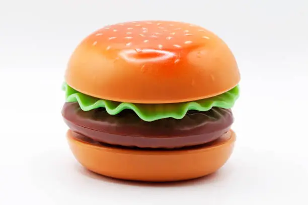 a plastic toy hamburger on a white background