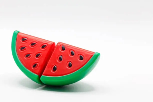 a plastic toy watermelon on a white background