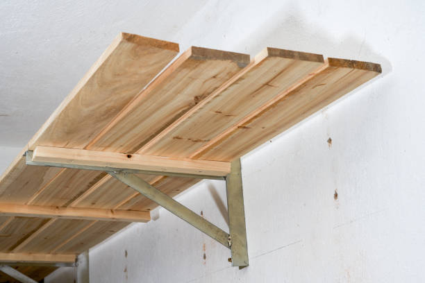 istock Close-up of a wooden shelf supported by a triangular iron frame on the wall 1487454699