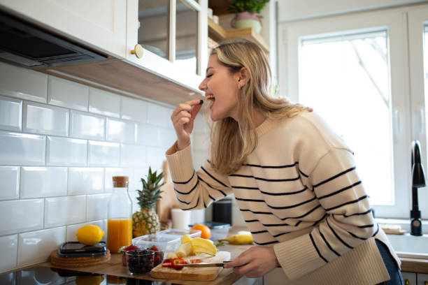 istock Woman preparing healthy fruit salad 1487455665