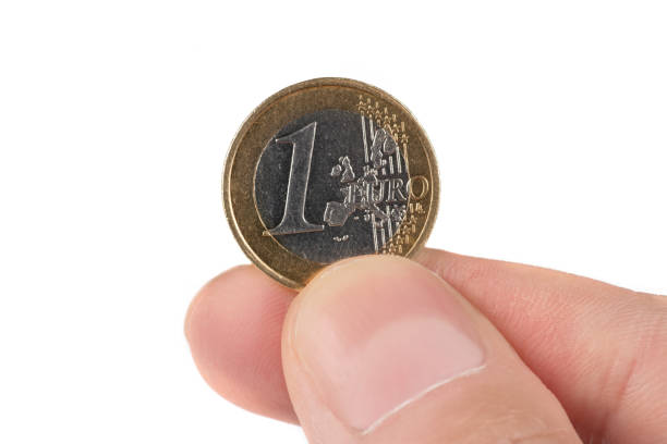 istock A hand holding one euro coin with white background 1487456131