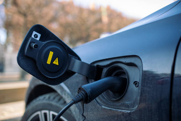 istock Electric car charging in public place 1487456210