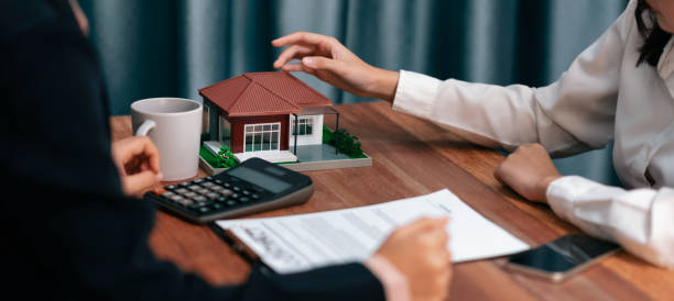 istock Reviewing house loan contract with agent using calculator. Enthusiastic 1487457477