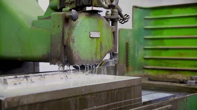 View of CNC Milling Machine Produces Metal Detail on Factory using liquid